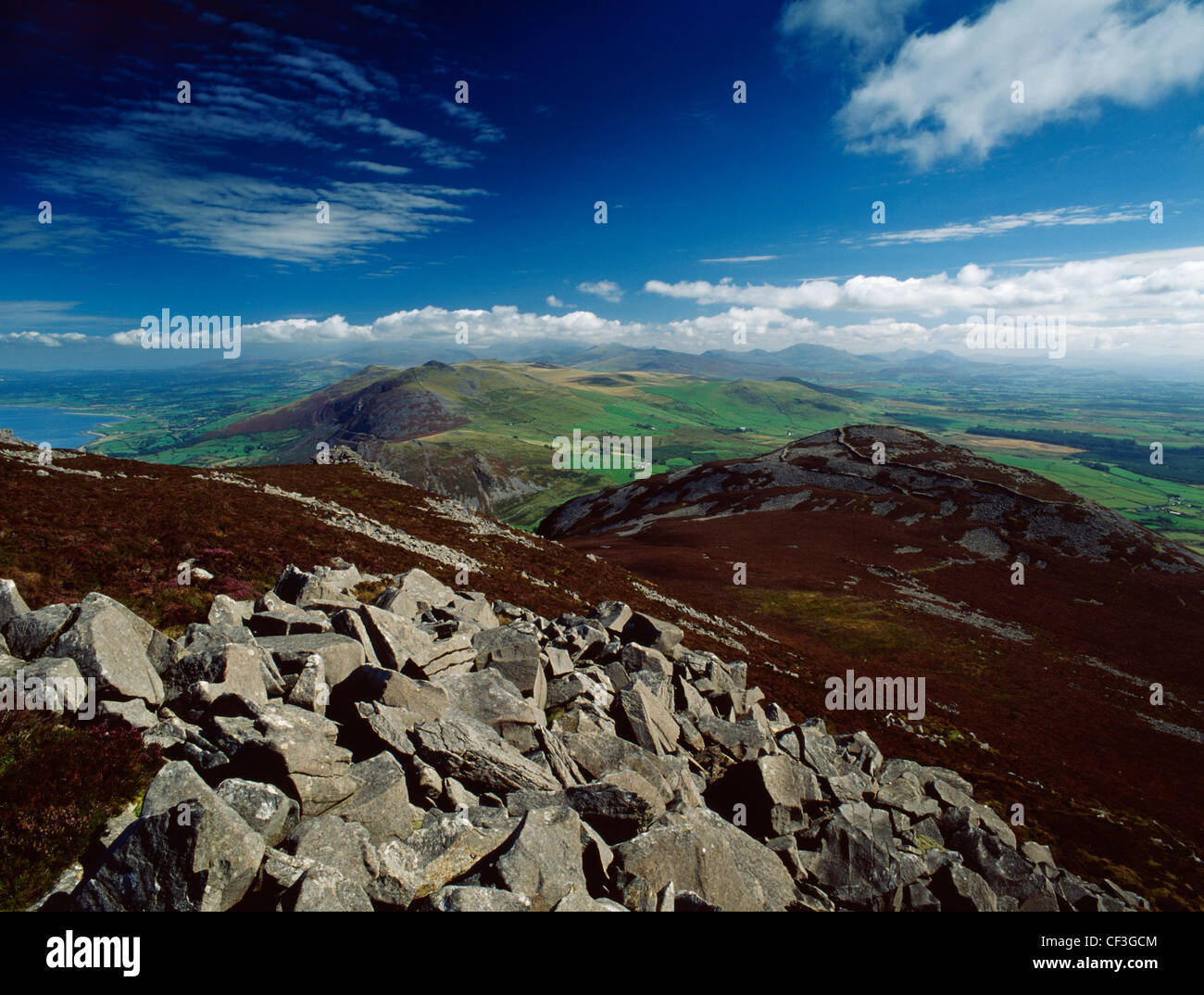 A wide view from the summit of Yr Eifl to the peaks of the Snowdon Range looking over the NW part of the Lleyn Peninsula, the co Stock Photo