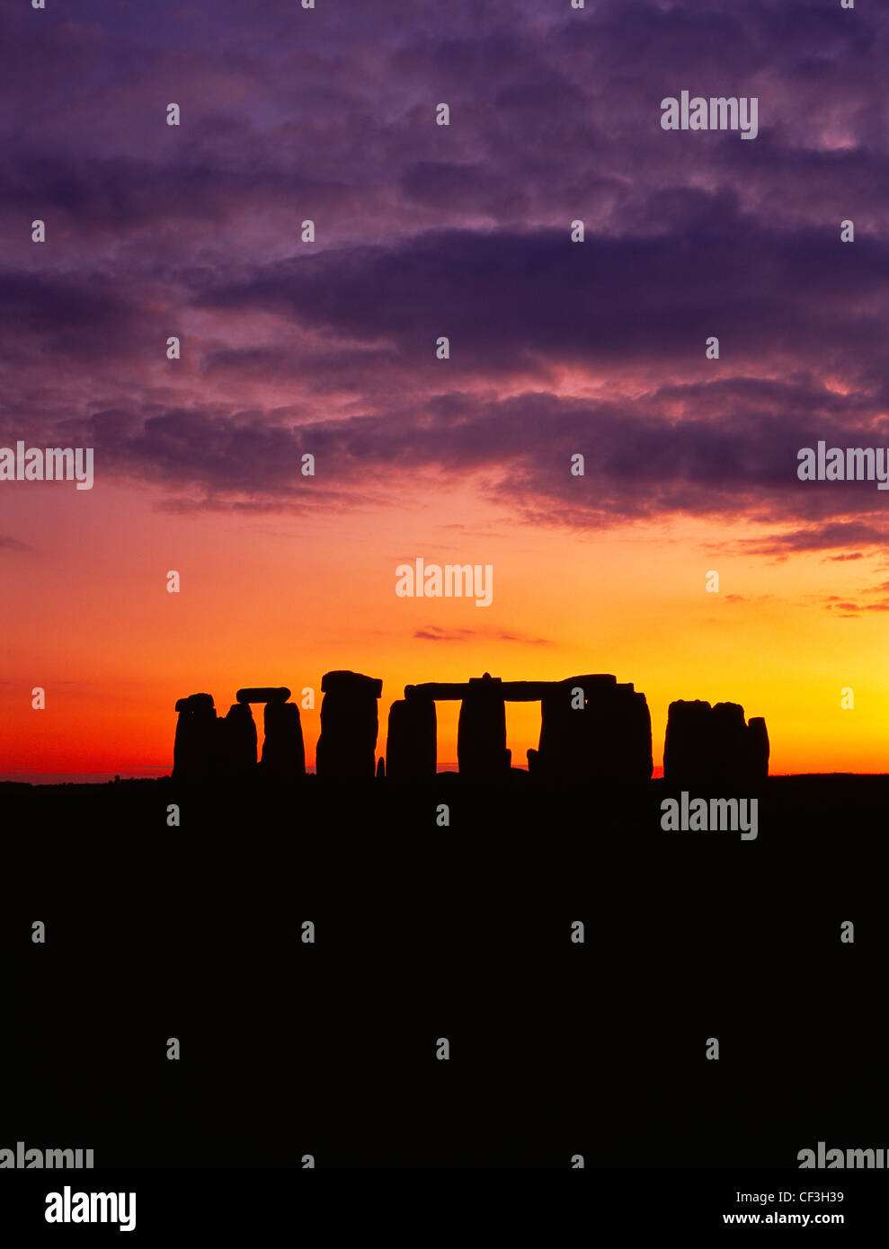 The Stonehenge trilithons silhouetted after sunset. Stock Photo
