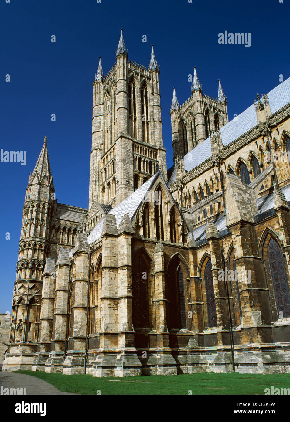 The western end of Lincoln Cathedral showing part of the exterior of the Early English Gothic nave and the Perpendicular towers Stock Photo