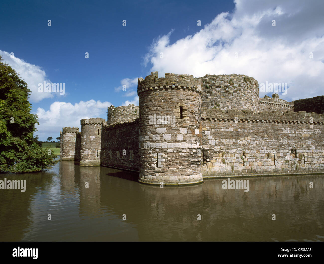 Looking across the moat at the SW tower and outer curtain wall of Edward I's Beaumaris Castle. The towers and walls of the inner Stock Photo