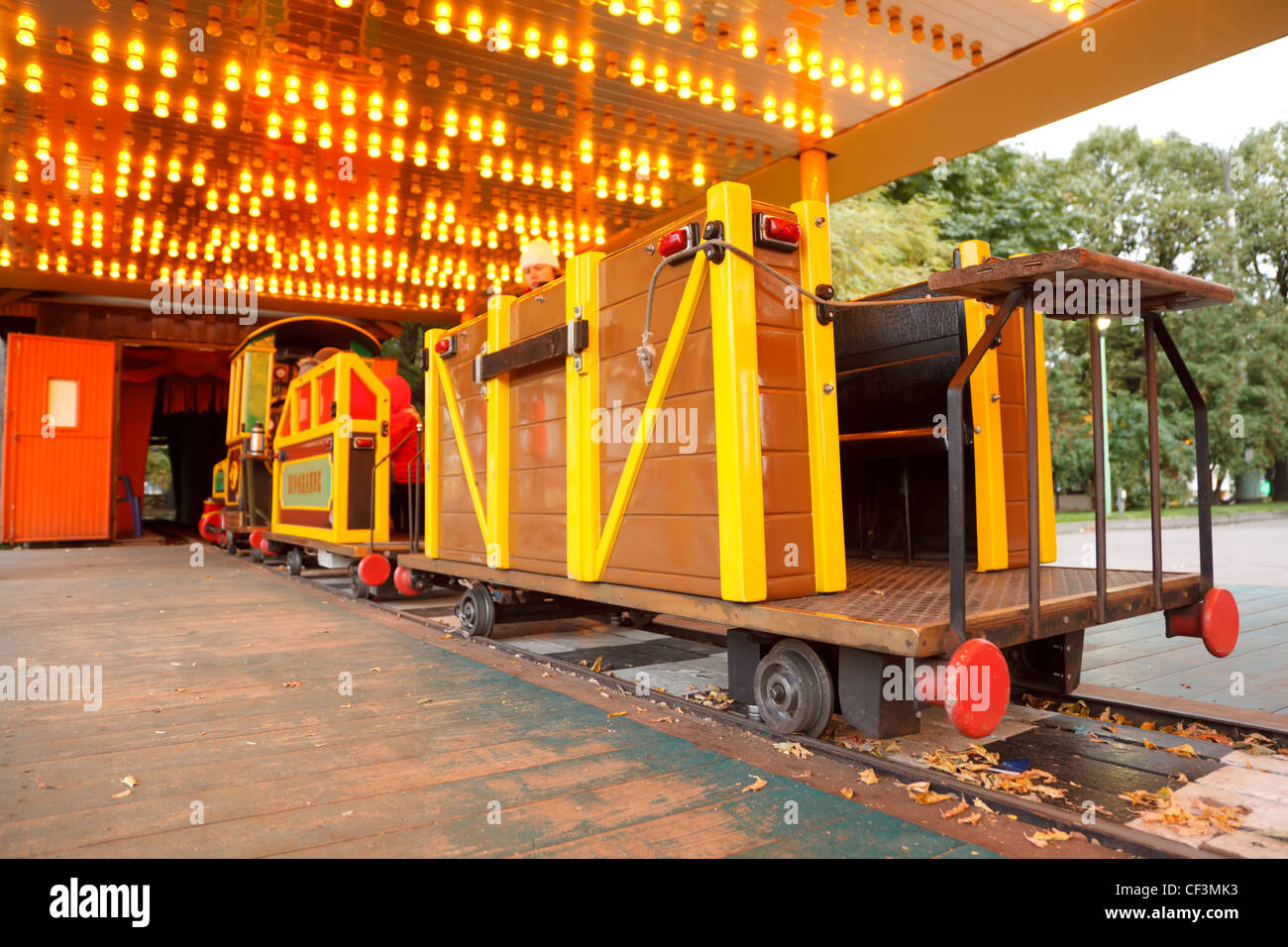Attraction in park. Children's railway, train with bright cars. Stock Photo