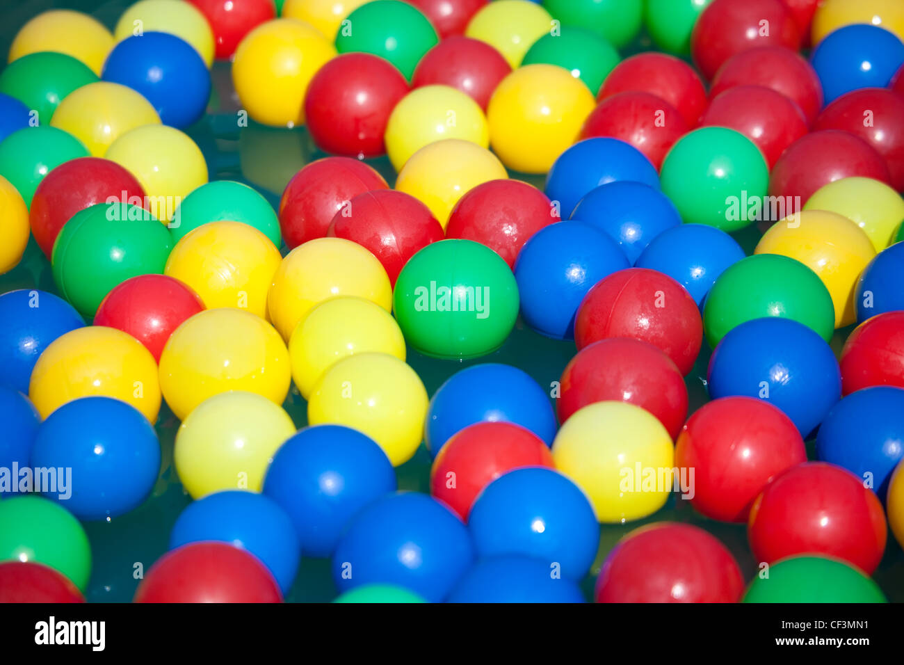 Multicoloured balls float on water Stock Photo Alamy