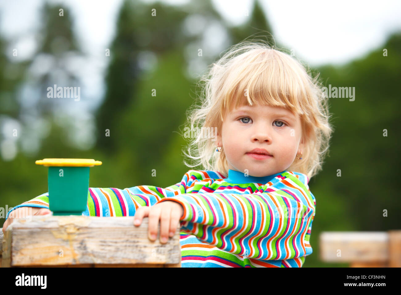 Portrait of the girl on a playground with a toy Stock Photo - Alamy