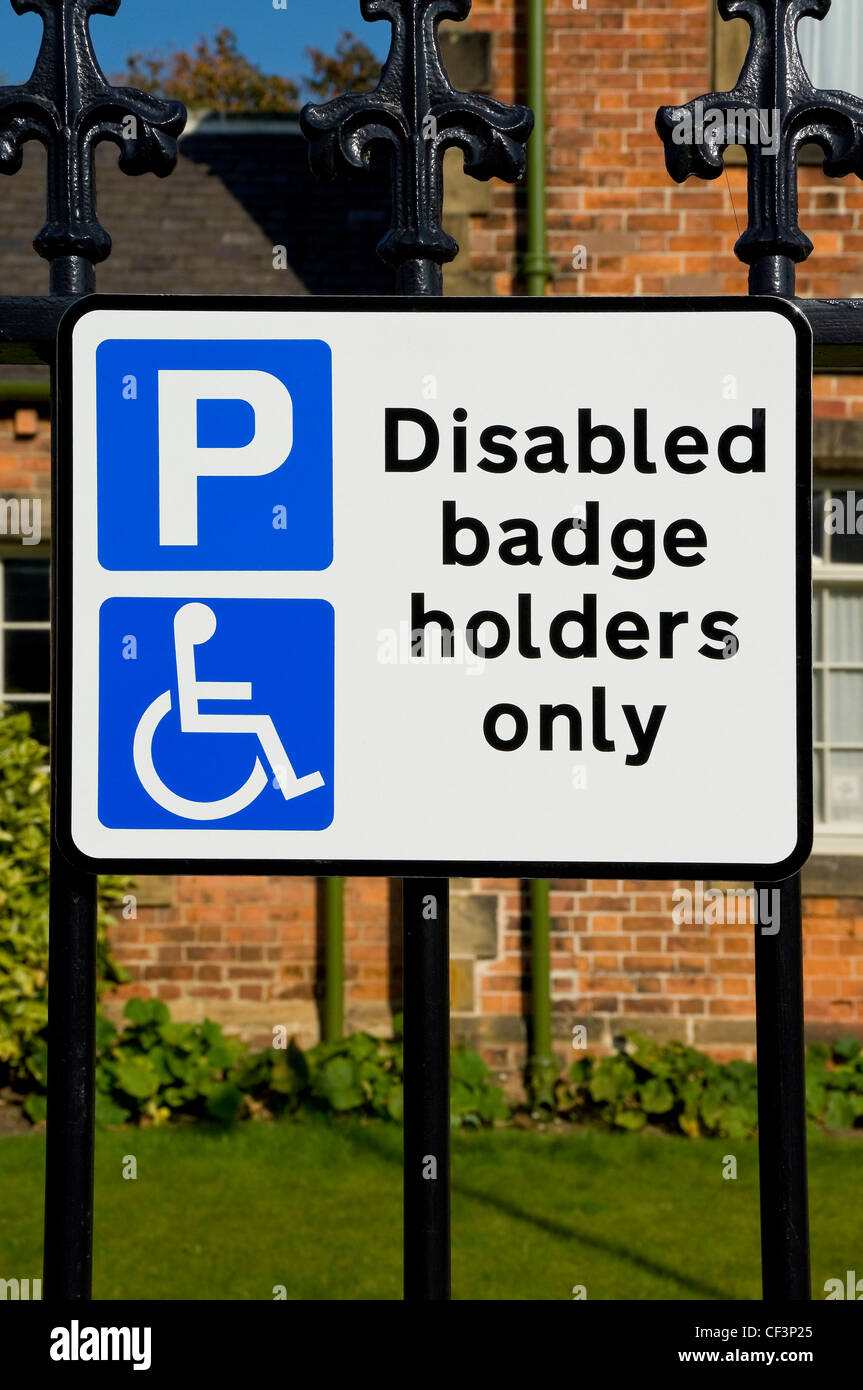 Parking sign displaying 'Disabled badge holders only', on street Stock