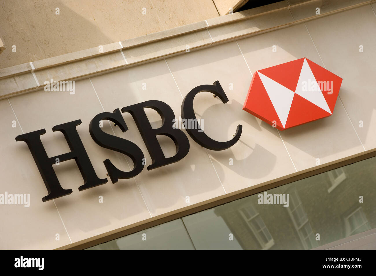 An HSBC bank sign above a branch of the bank. Stock Photo