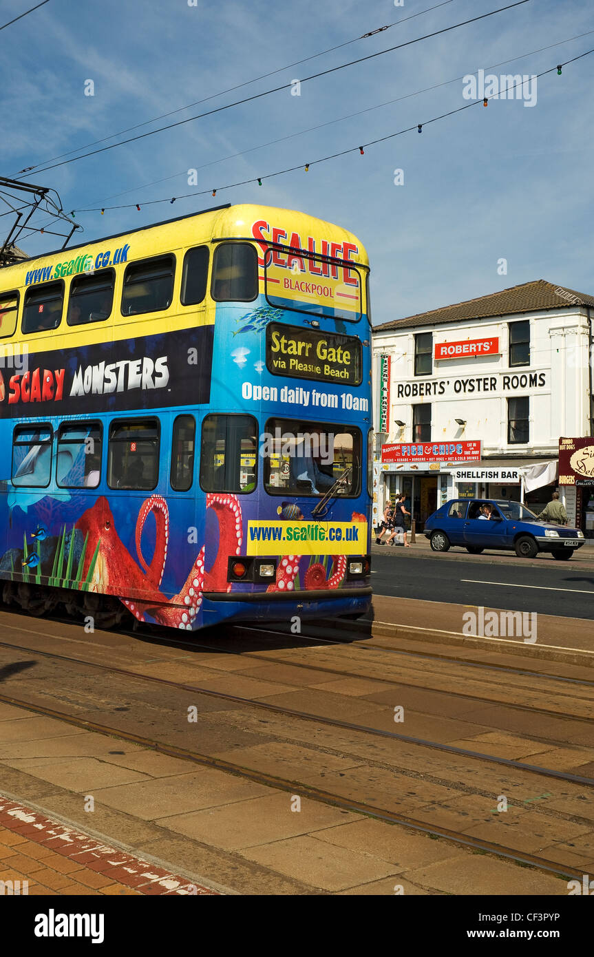 An electric tram travelling along Blackpool's Golden Mile. Stock Photo