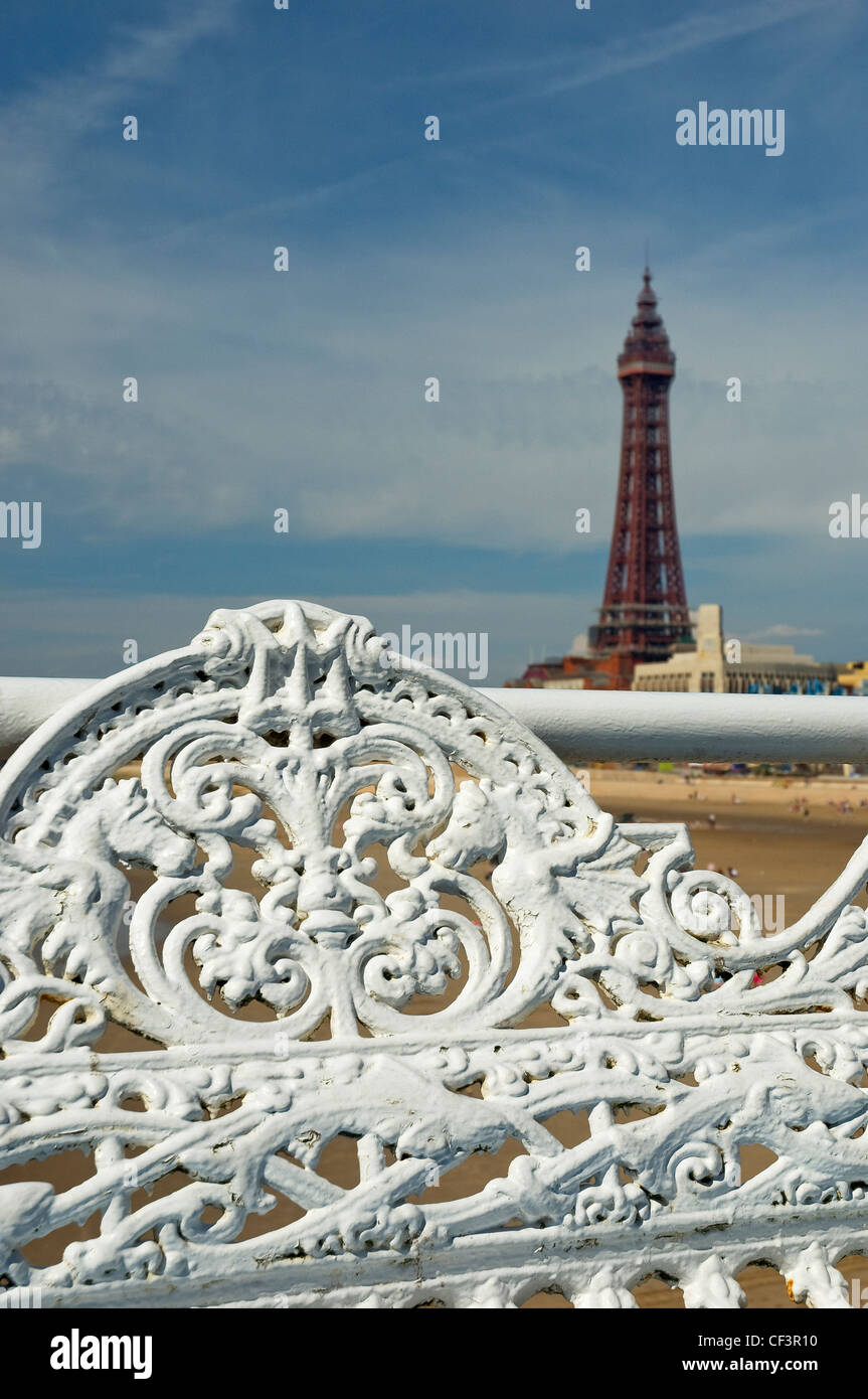 Ornate seating on central pier with Blackpool Tower in the background. Stock Photo