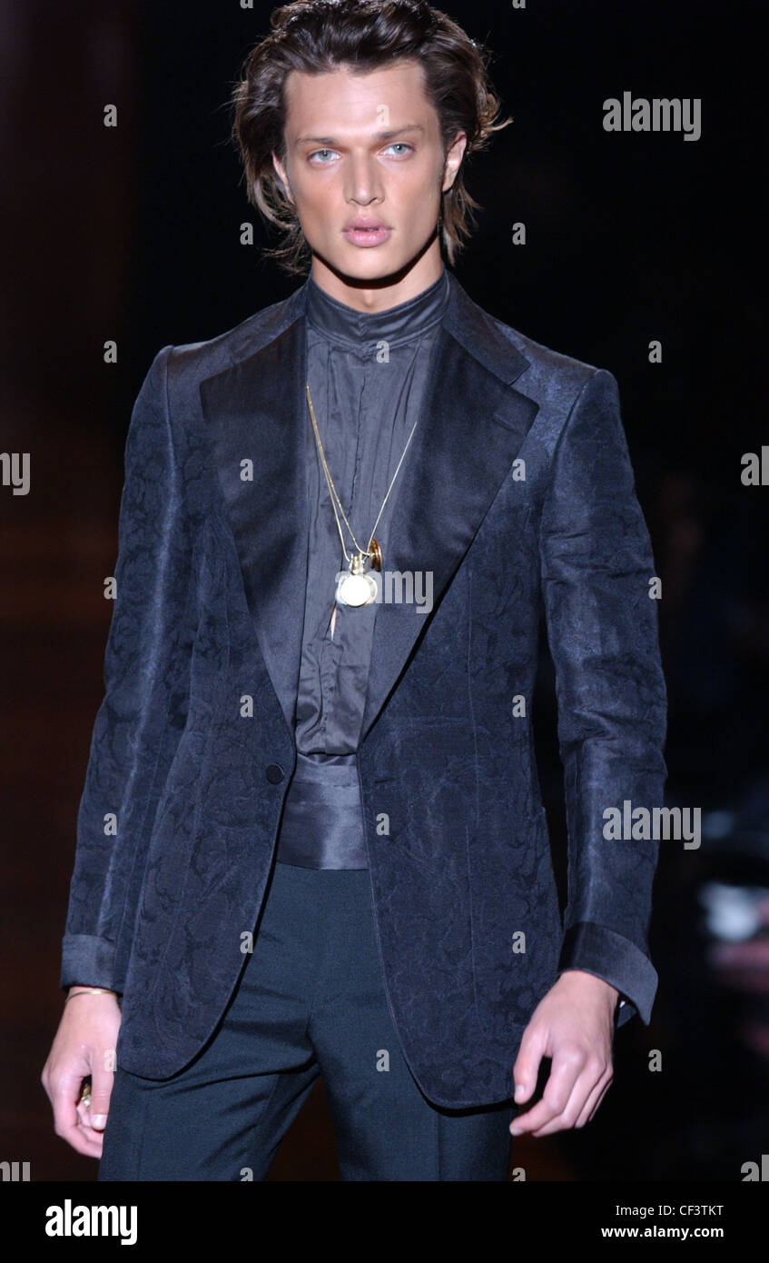 Gucci Menswear Ready to Wear Spring Summer Model long brown hair wearing  gold medallion chains, dark blue silk shirt, dark Stock Photo - Alamy