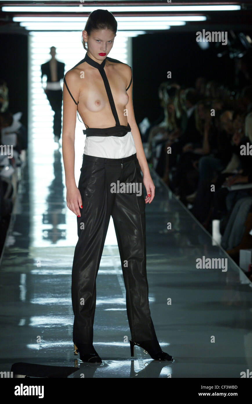 topless-catwalk-models Jens Laugesen London Ready To Wear Spring Summer Topless model brunette  hair off face wearing fetish strap top and shiny Stock Photo - Alamy