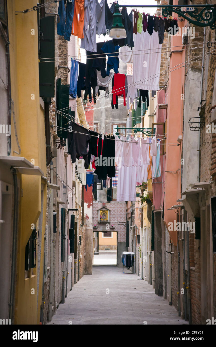 Laundry drying on clothesline between two buildings in Castello