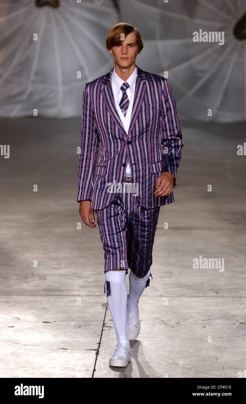 Alexander McQueen Milan Menswear S S Male wearing purple striped suit Knickerbockers and long white socks Grey patterned Stock Photo