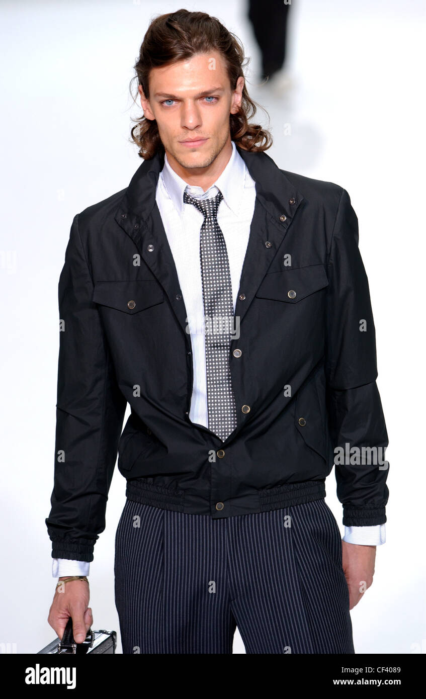 Givenchy Paris Menswear S S Male model wearing black causal jacket over  white shirt with spotted tie and pinstriped trousers Stock Photo - Alamy