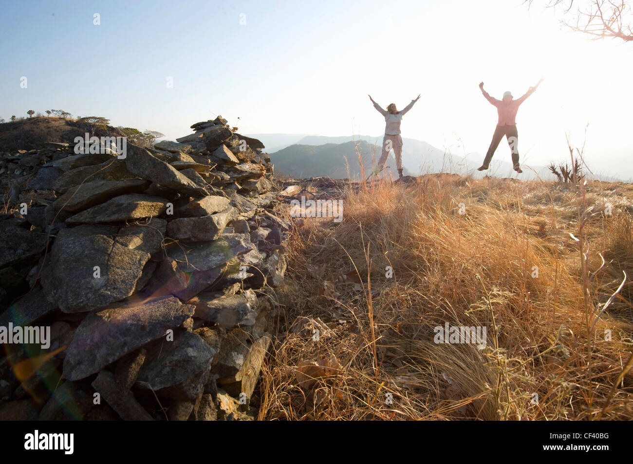 Hikers celebrate reaching the top of the hill Stock Photo - Alamy