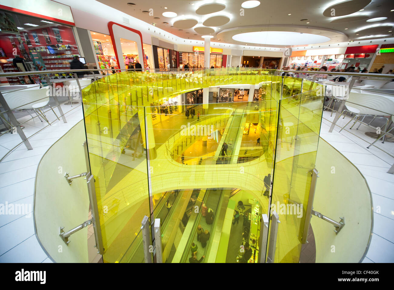 Escalator, stores, cafe, snackbar and many buyers and customers in shopping centre Stock Photo