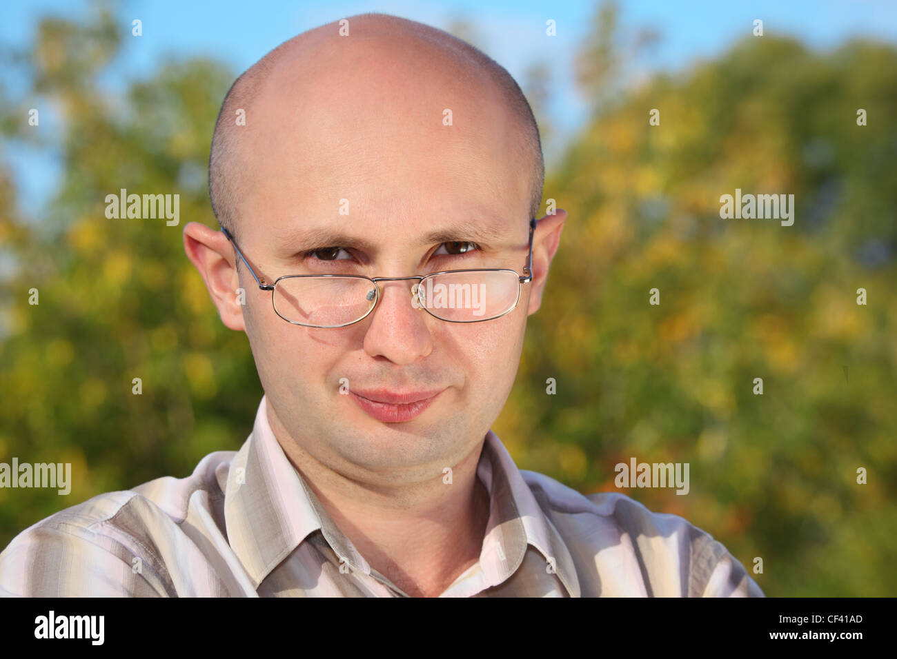 handsome man with glasses in fall park looking at camera Stock Photo