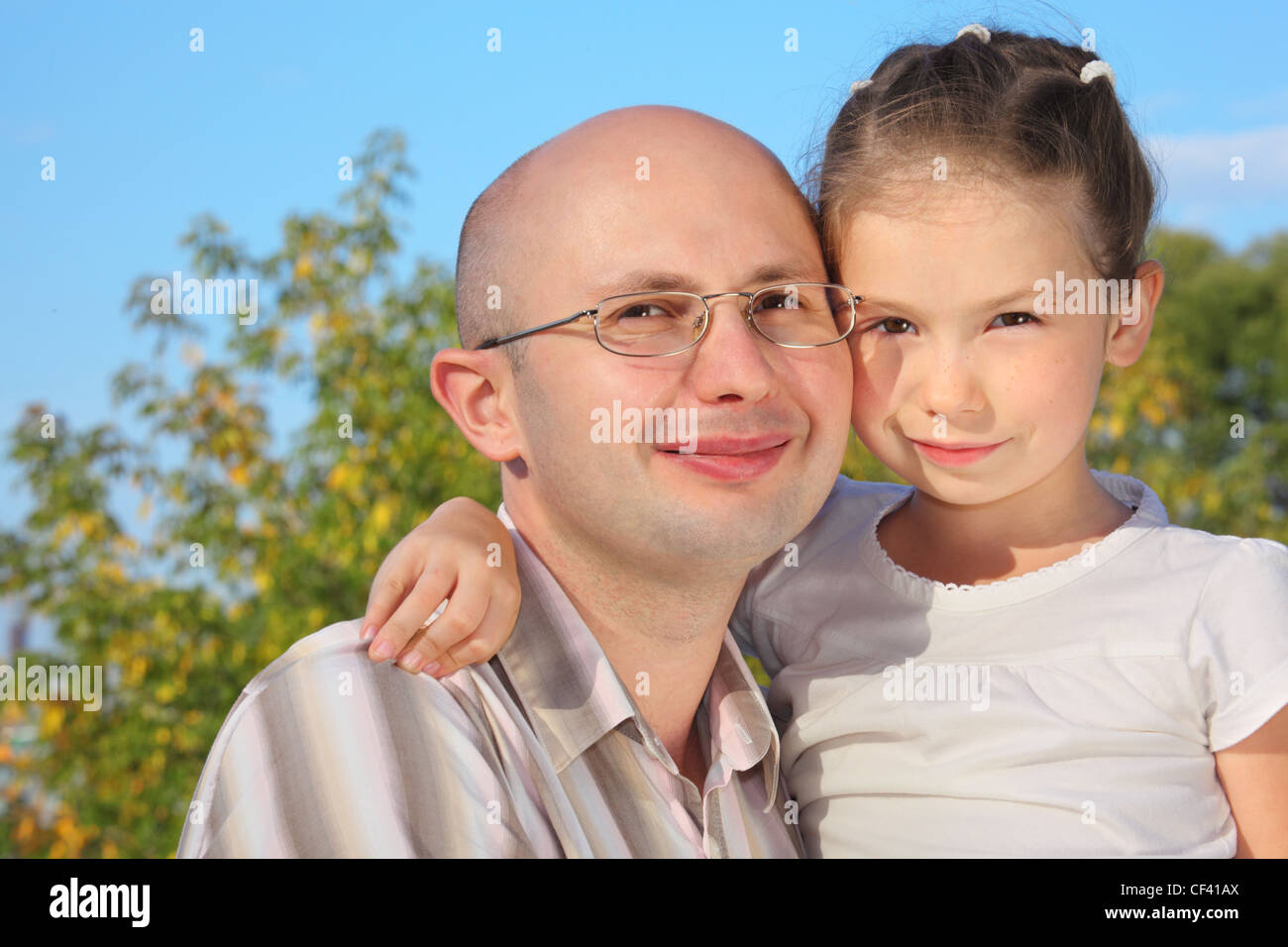 handsome man with his little daughter in early fall park. Stock Photo