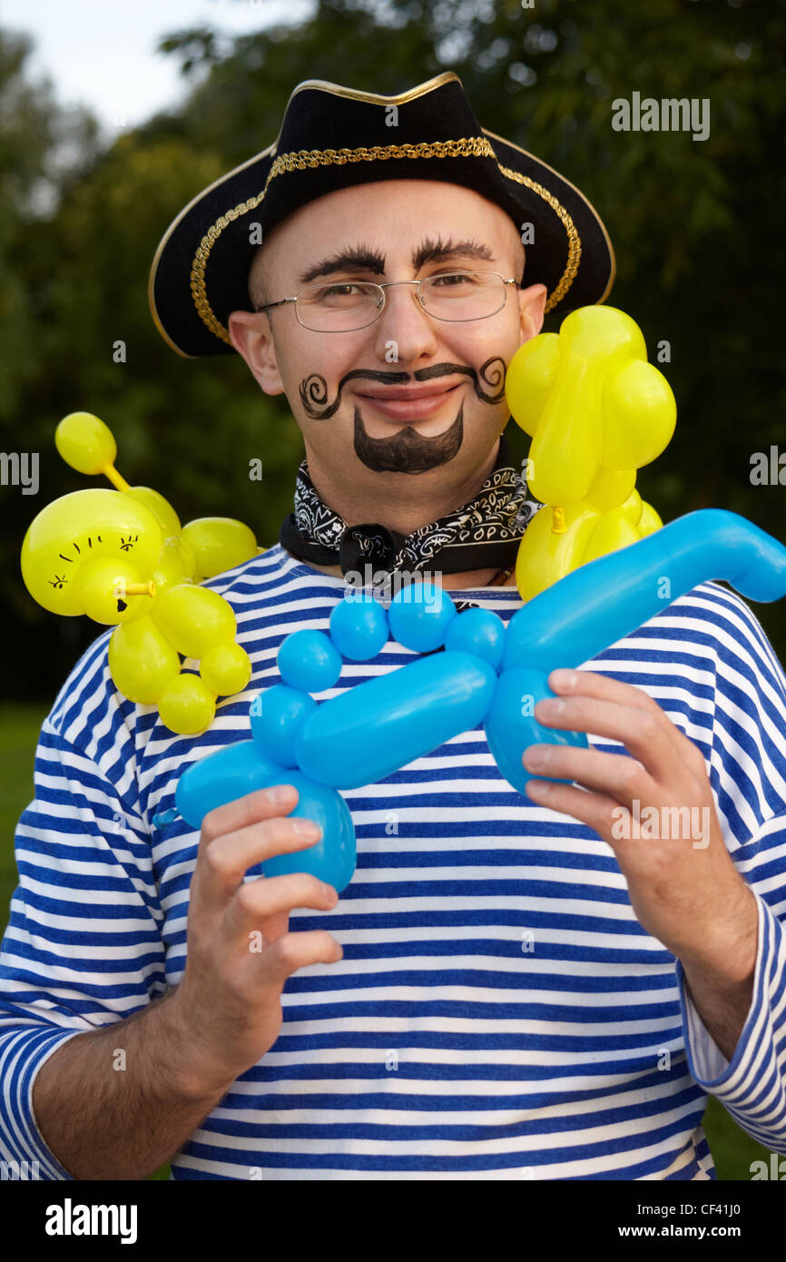 smiling man with drawed beard and whiskers in pirate suit with three air-ballons Stock Photo