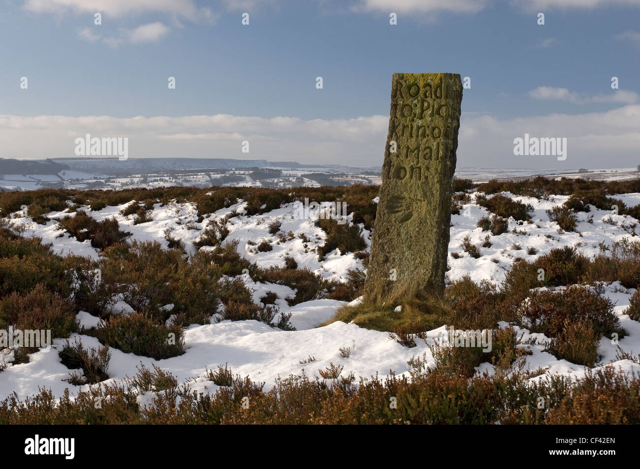 Snow carpets the moorland around an old Waymarker on Spaunton Moor