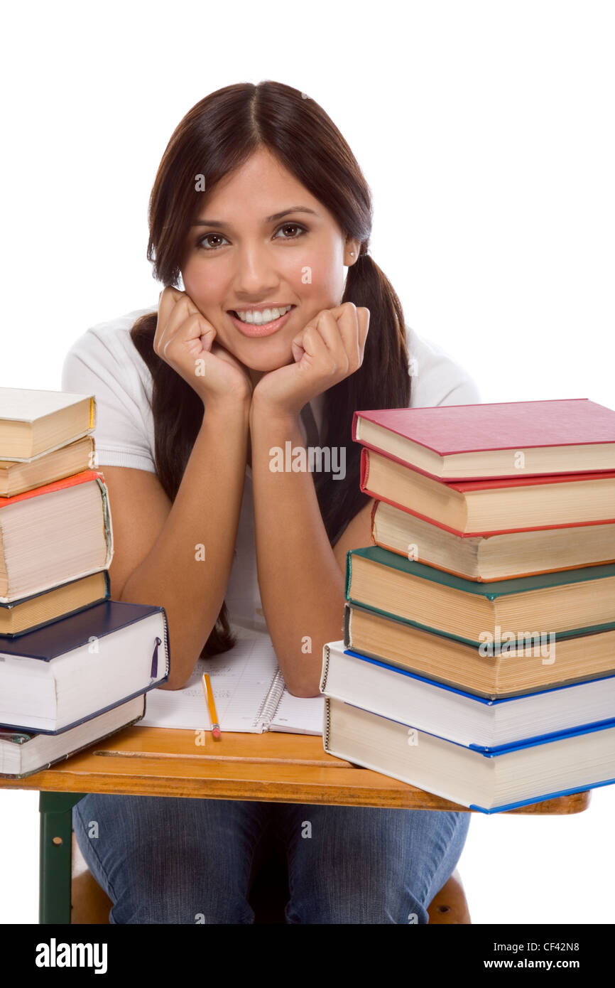 education series - Friendly ethnic Latina female high school student with books by desk Stock Photo
