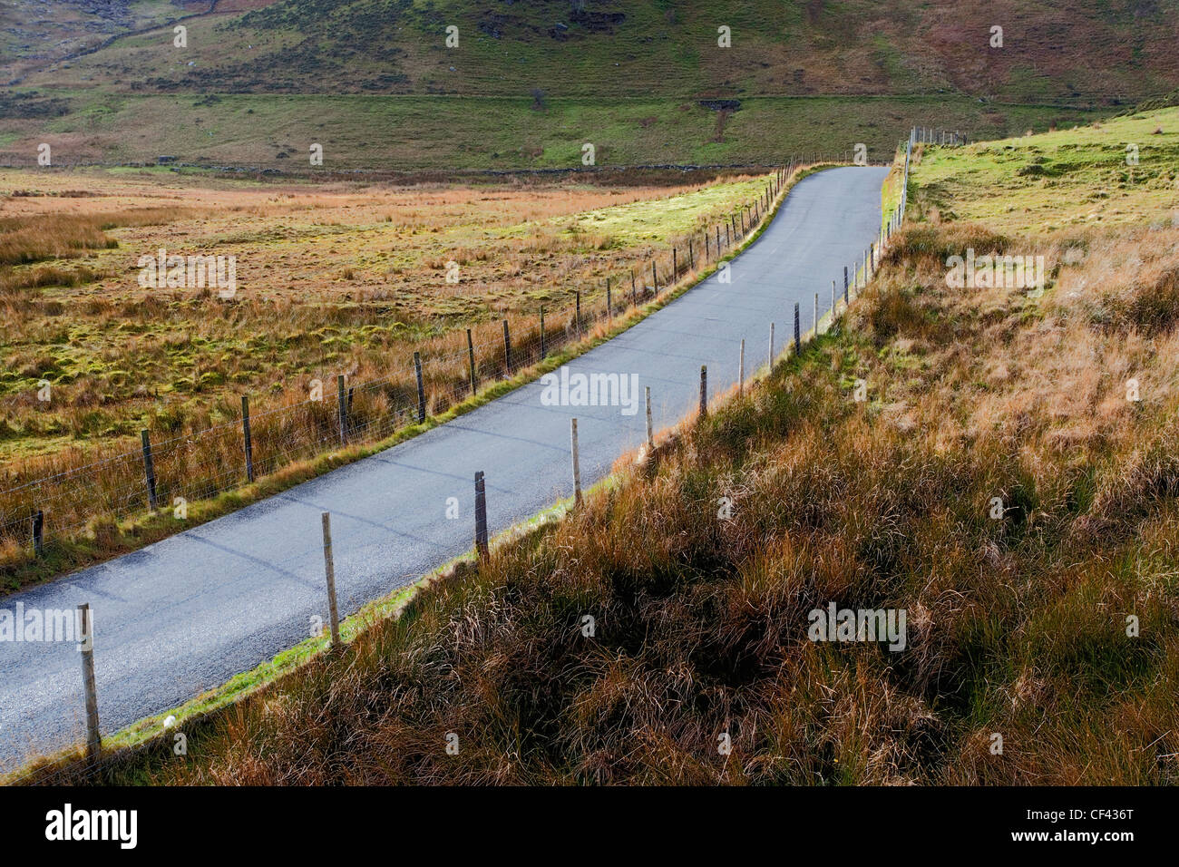 A small road running through the mountainous Snowdonia landscape. Stock Photo
