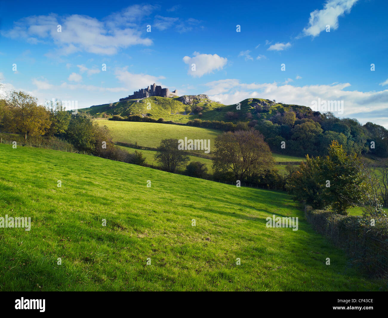 View across rolling hills towards Carreg Cennen Castle. Stock Photo