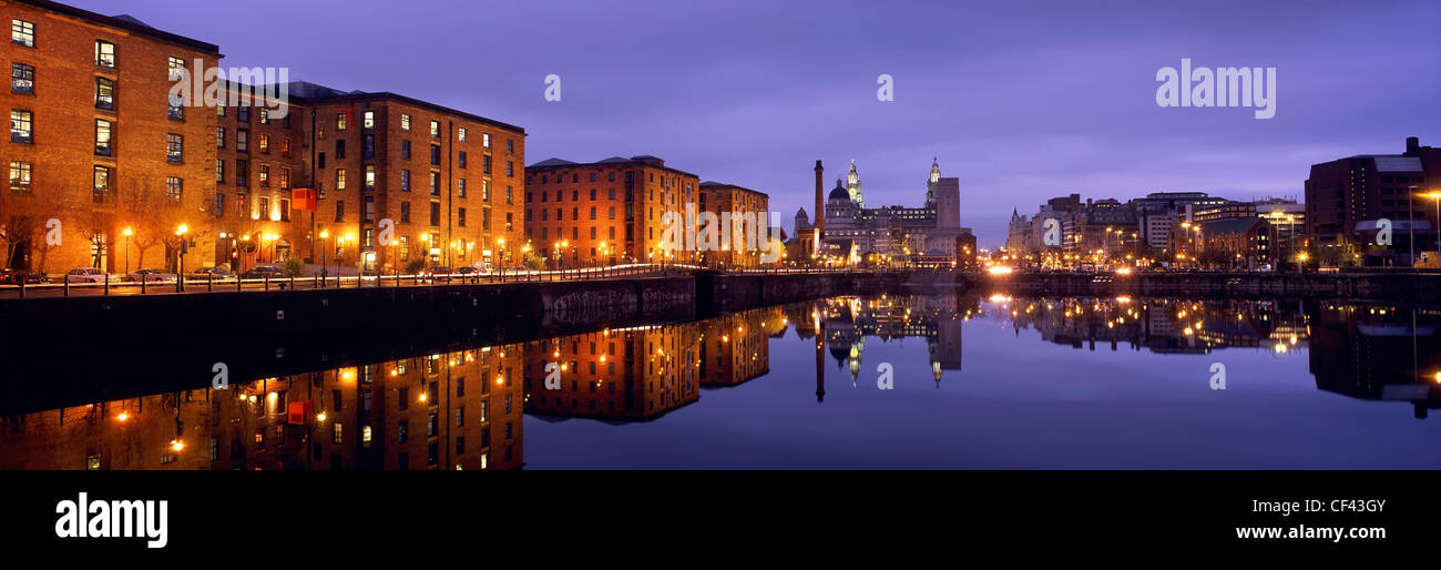 View across the Albert Dock towards the Liver Building as twilight descends. Stock Photo