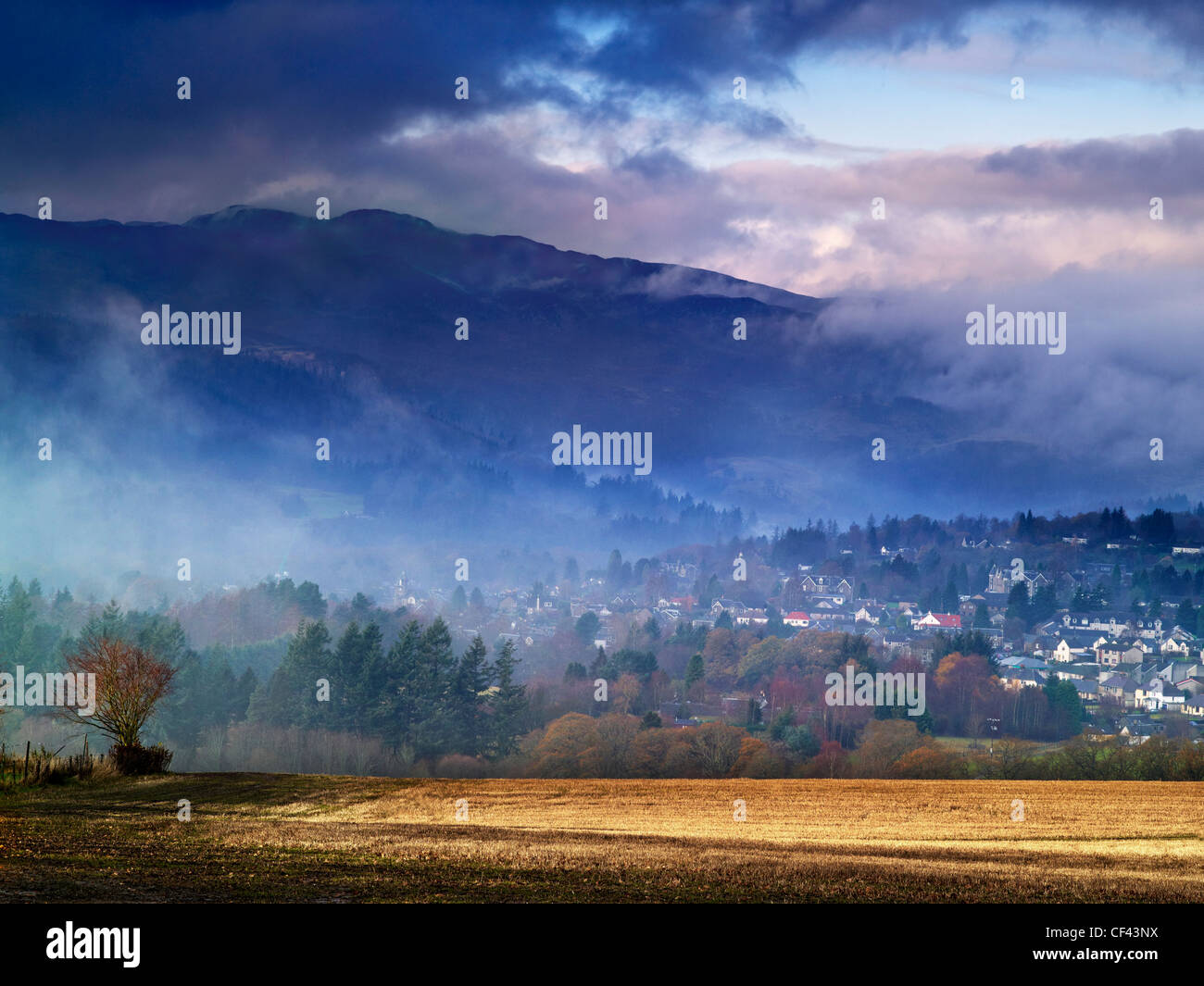 A misty dawn over the town of Pitlochry. Stock Photo