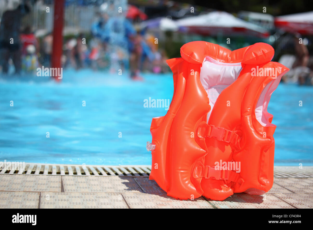 orange lifejacket near pool in aquapark Stock Photo