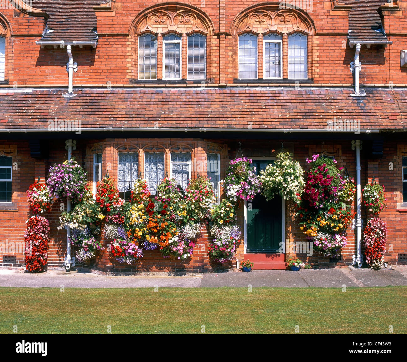 Flower baskets outside cottages in Port Sunlight. The houses were originally built for employees of Lever Brothers, soap manufac Stock Photo