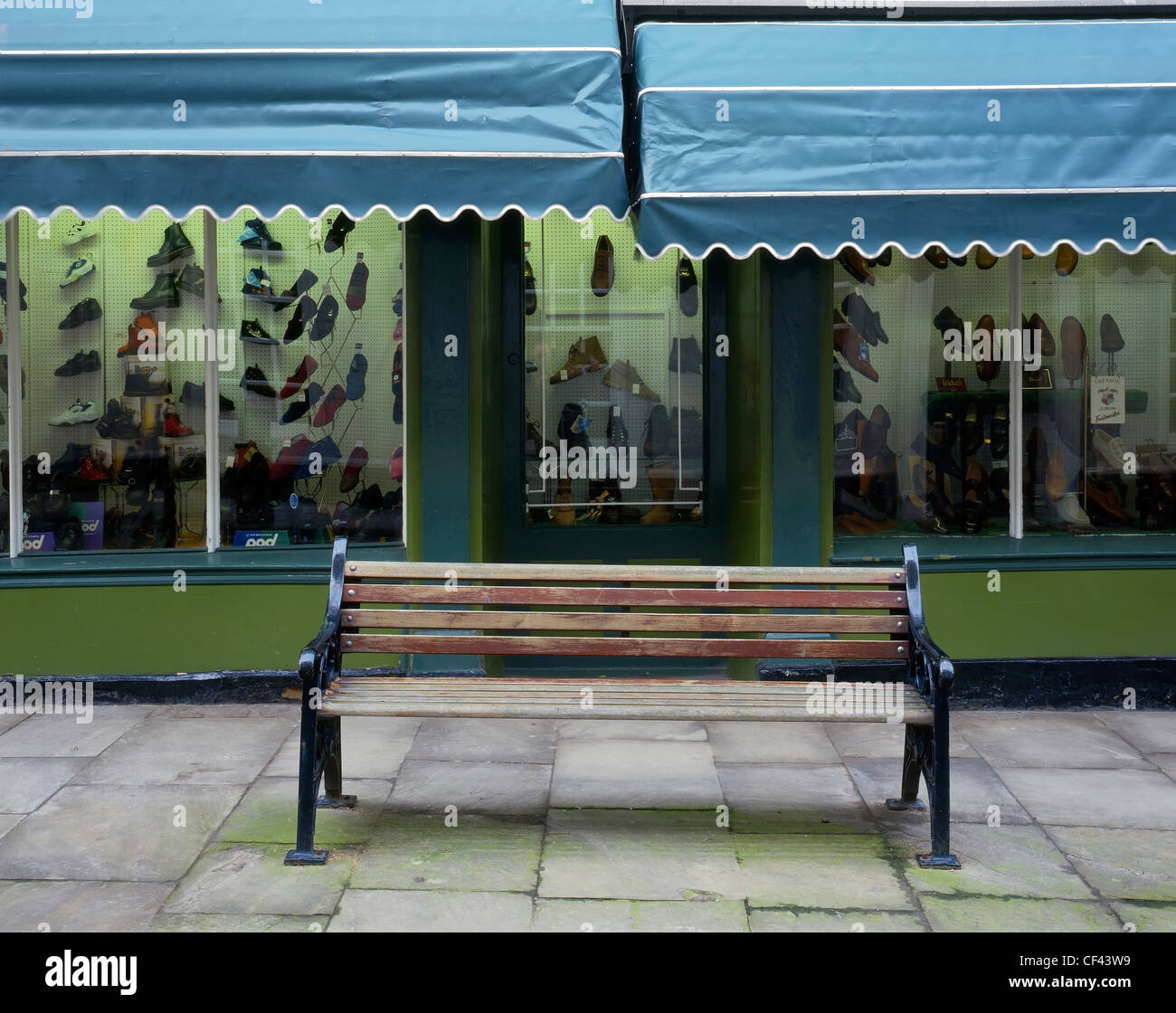 A bench outside a traditional shoe shop in the old part of Bridlington. Stock Photo