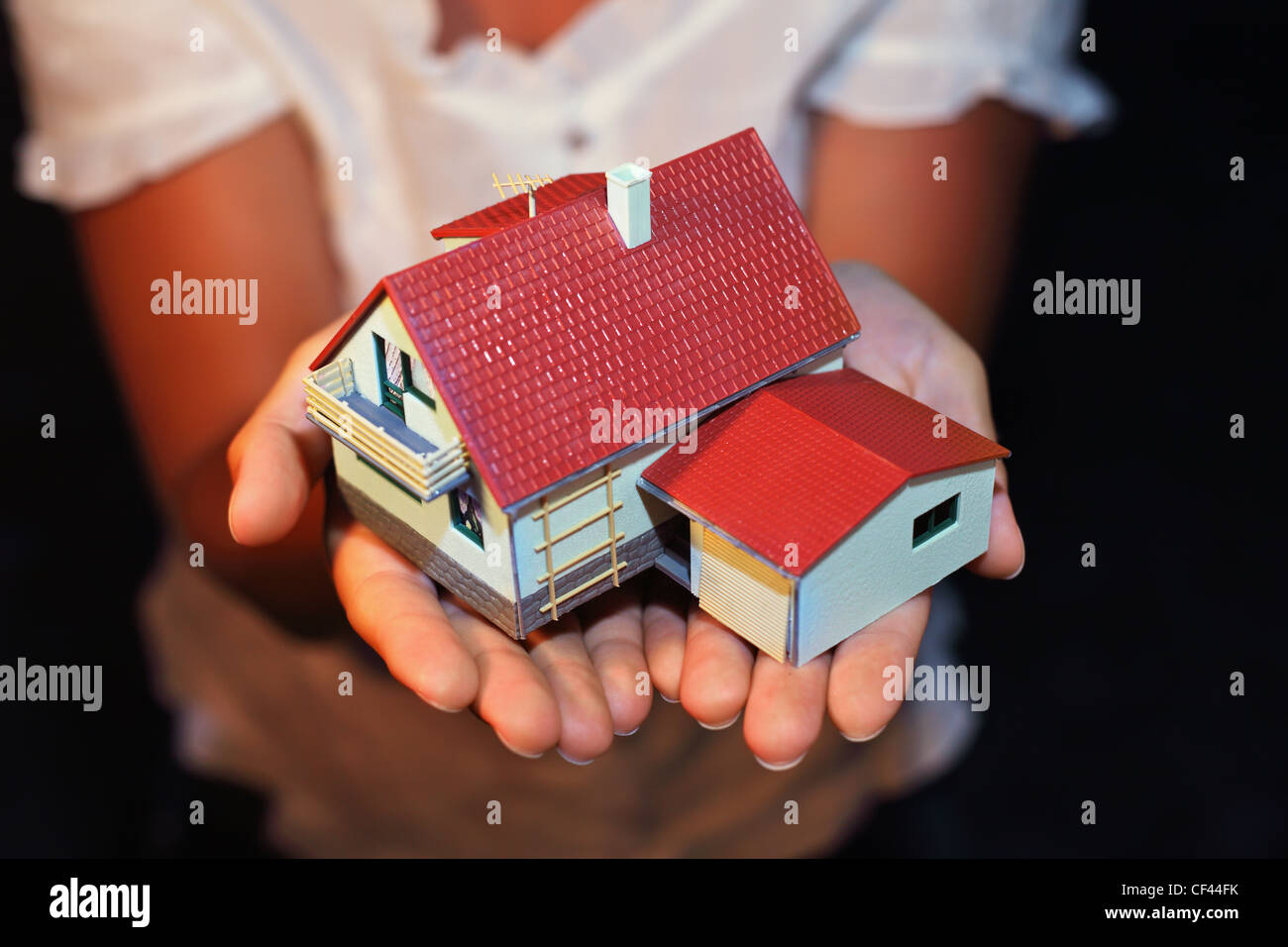 model of house with garage on hands Stock Photo