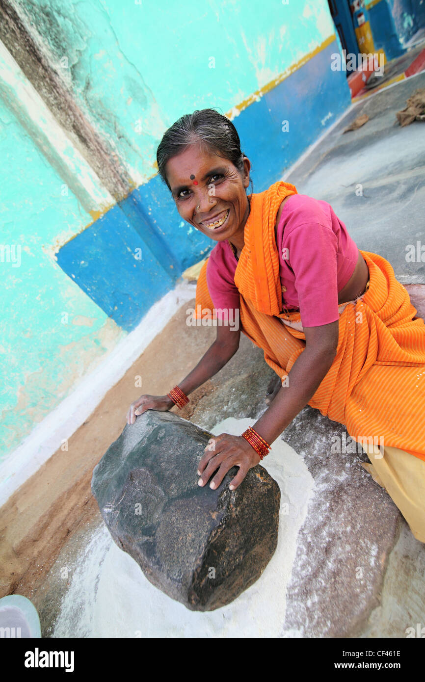 Rural woman using a grounding stone Andhra Pradesh South India Stock Photo