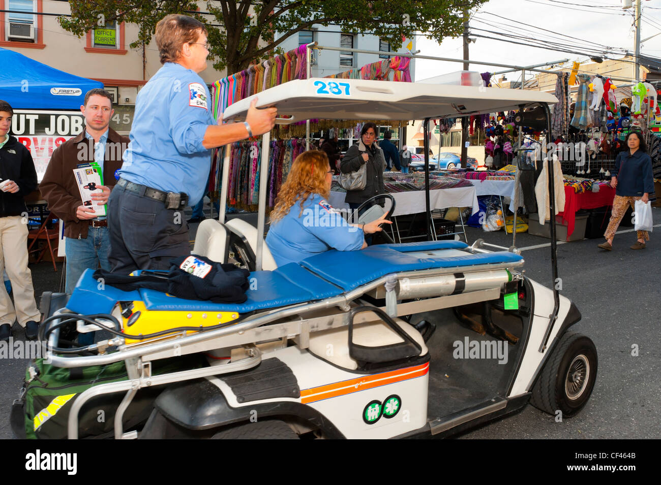 Two female EMT, Emergency Medical Technicians, on rescue cart racing to help at Merrick Street Fair, Merrick, New York, USA 2012 Stock Photo