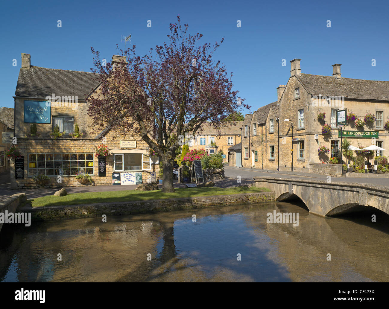 Looking across the River Windrush to Kingsbridge Inn at Bourton on the