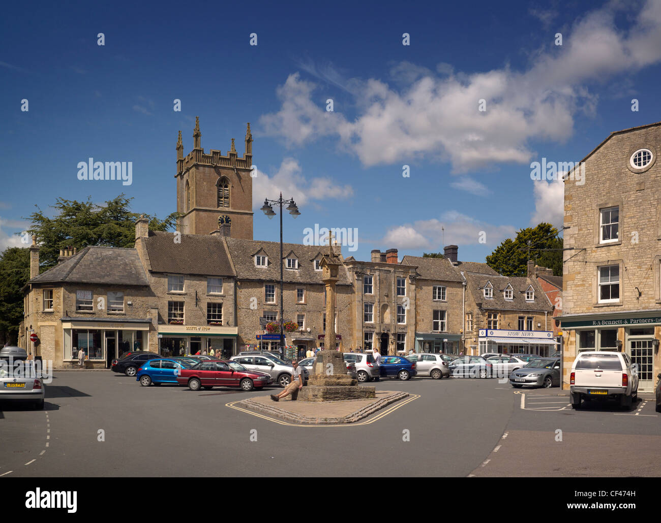 The church tower and sandstone buildings of Stow on the Wold in the Cotswolds. Stock Photo