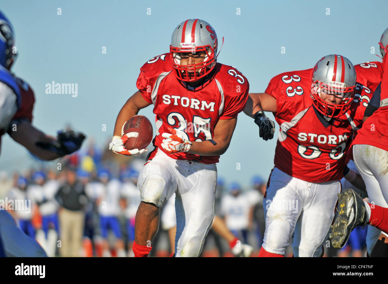 Running back being escorted into the end zone by his backfield running mate during a high school football game. USA. Stock Photo