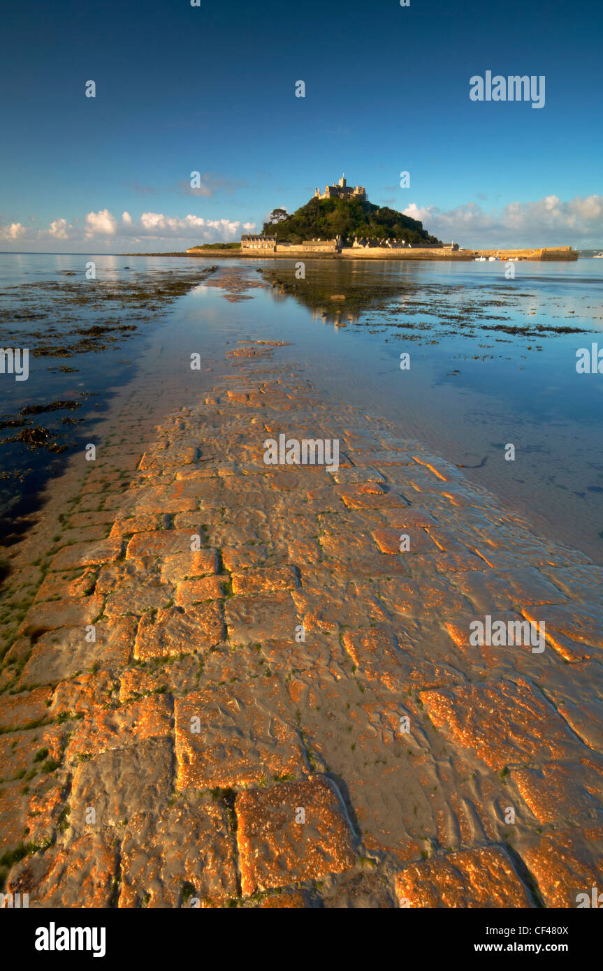 Dawn over the old stone causeway leading to St. Michaels Mount off the Cornish coast. Stock Photo