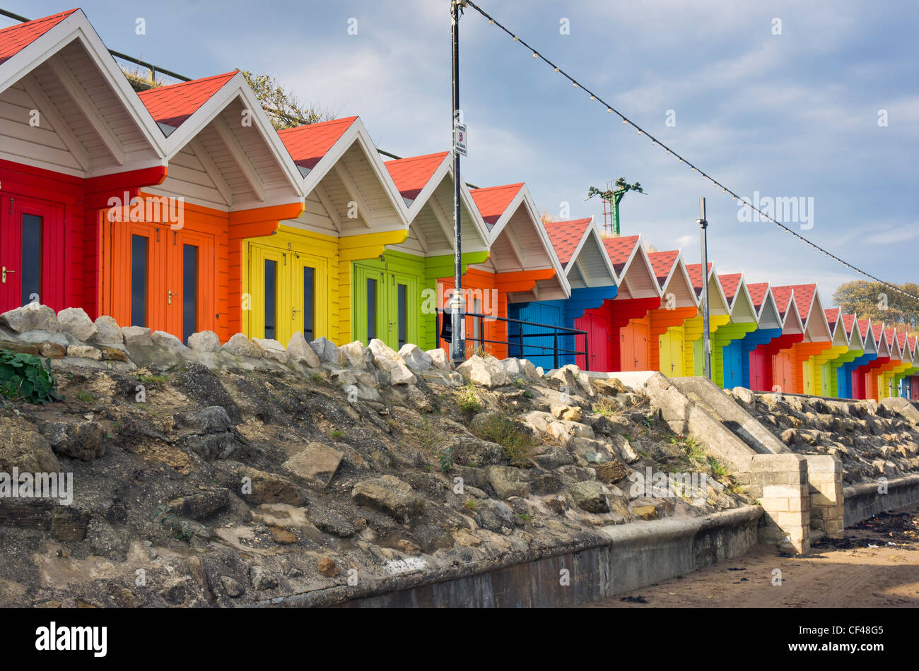 Traditional colourful beach chalets located on the North Bay promenade. Stock Photo