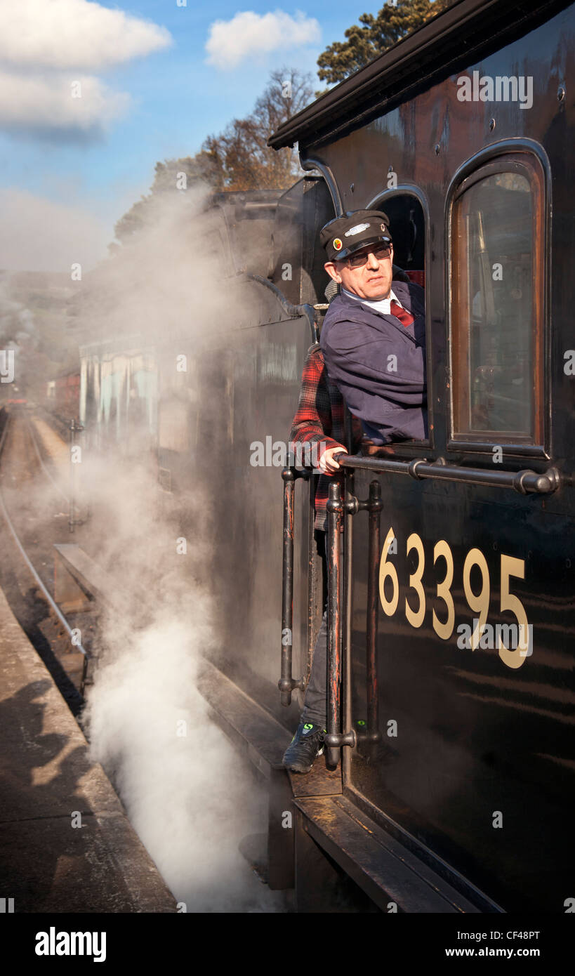 Steam Train and driver at Grosmont station on the North Yorkshire Moors Railway. Stock Photo