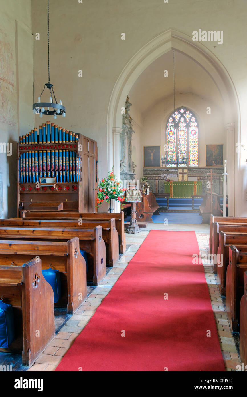 The aisle and pews inside St Mary the Virgin. The church is home to a number of outstanding medieval wall paintings dating from Stock Photo