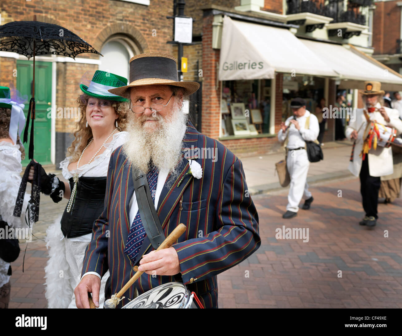 People dressed in Victorian costumes parading in the streets of Rochester at the Dickens Festival 2010. Stock Photo