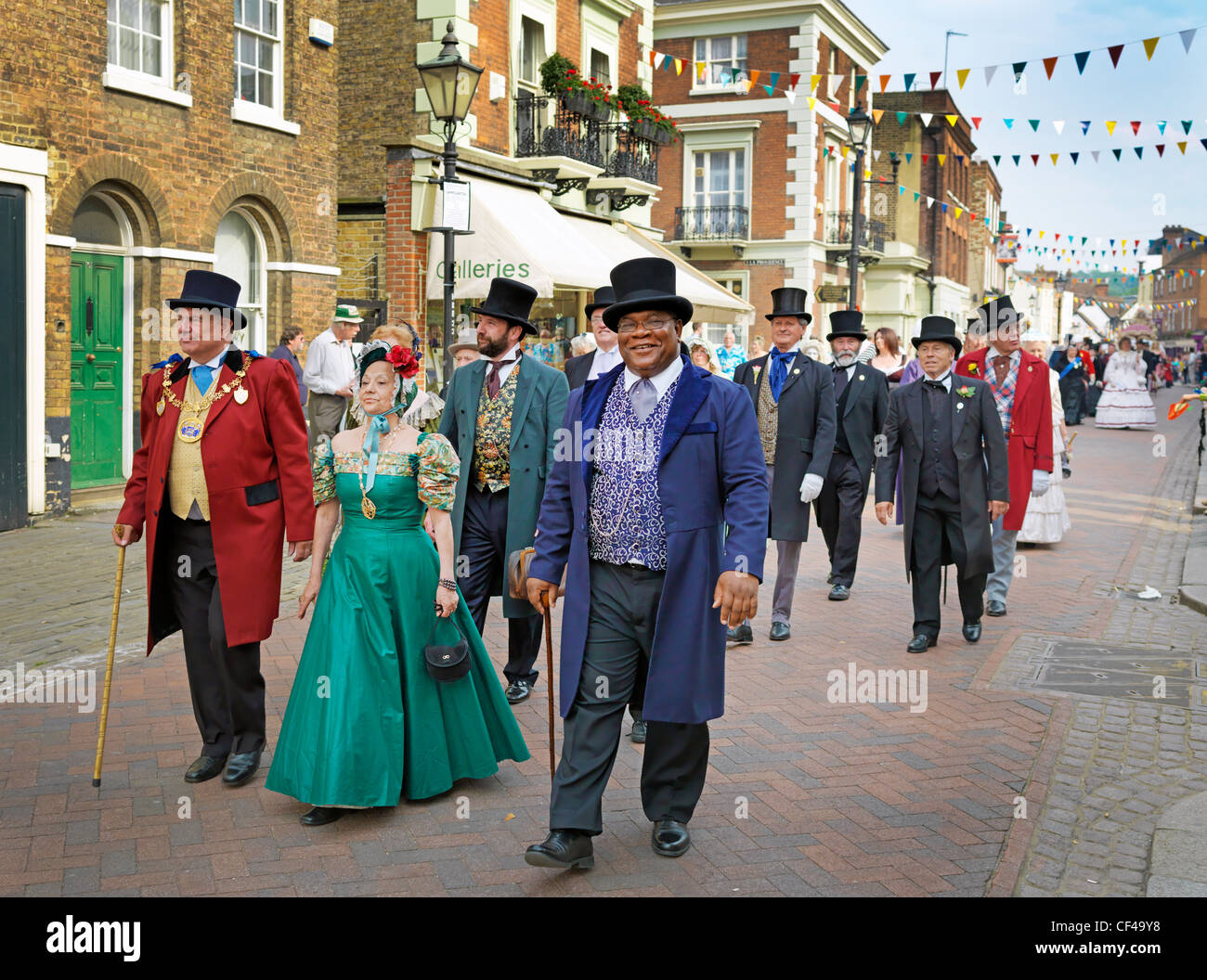 People dressed in Victorian costumes parading in the streets of Rochester at the Dickens Festival 2010. Stock Photo