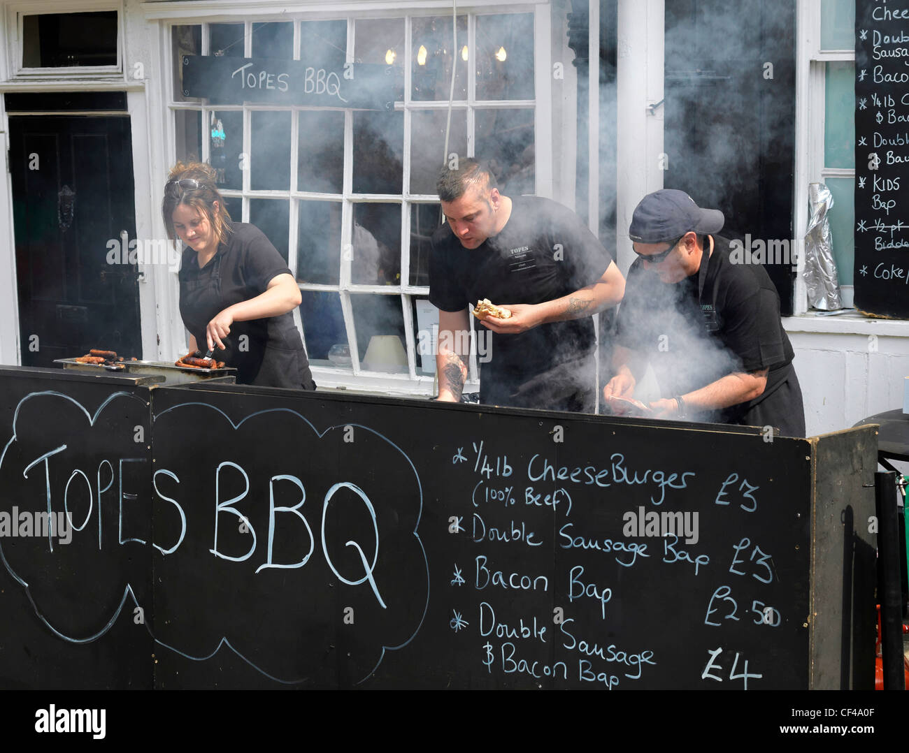 Staff from Topes Restaurant cooking food on their barbecue at the Dickens Festival 2010. Stock Photo