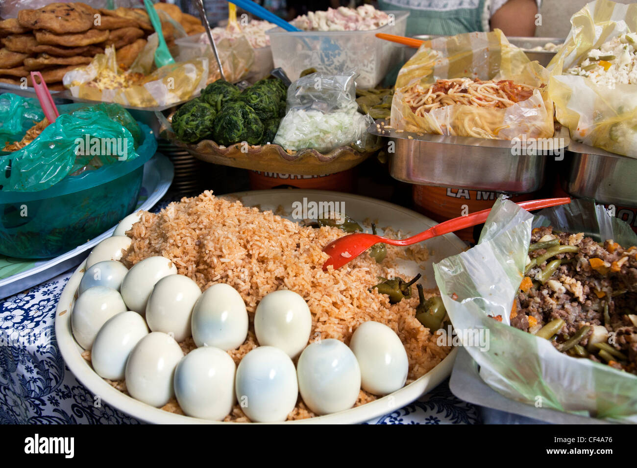 tempting array of wholesome healthy nourishing deli style prepared foods displayed on counter in Benito Juarez market Oaxaca Stock Photo