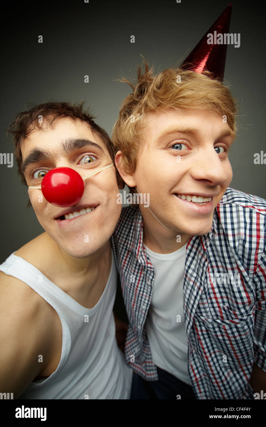 Two funny guys looking at camera and smiling crazily, fool’s day series Stock Photo