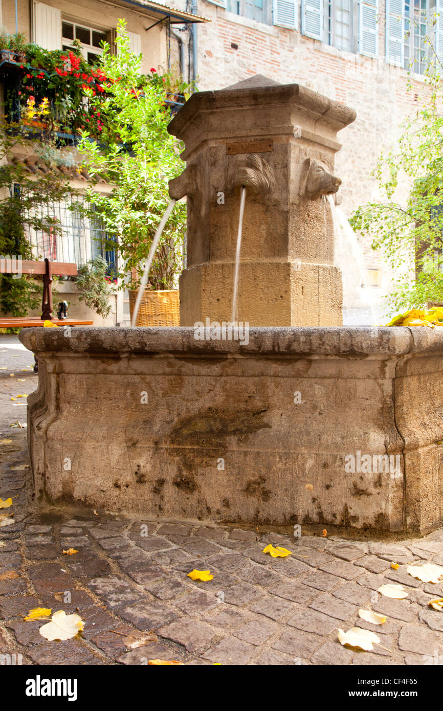 Old fountain in a square in the old quarter of Cahors, Midi-Pyrenees, France. Stock Photo