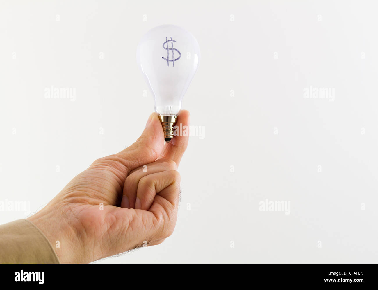 hand holding a lightbulb representing cost of energy Stock Photo