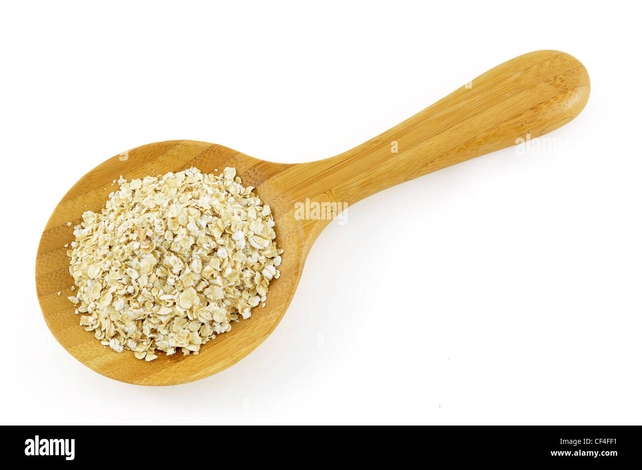 Crushed oats in wooden spoon on white background Stock Photo