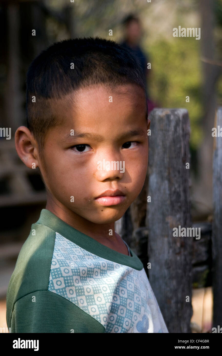 An young ethnic Karen refugee boy from Burma is relaxing at his home in ...