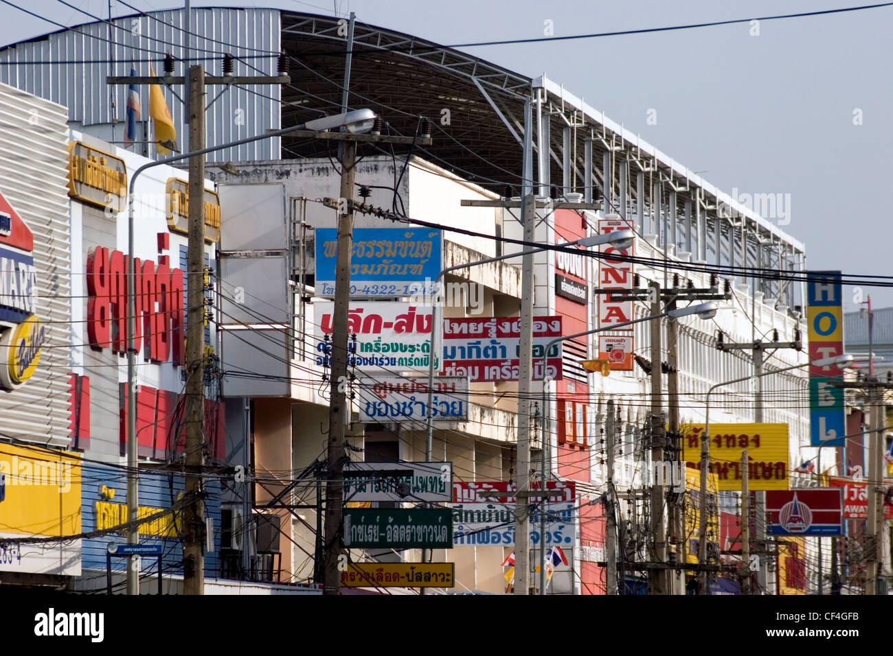Many signs written in Thai are part of the urban landscape on a city street in urban Khon Kaen, Thailand. Stock Photo